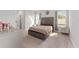 Bedroom featuring elegant bed, mirrored accents, and plenty of natural light through large windows at 14055 Sw 30Th Terrace Rd, Ocala, FL 34473