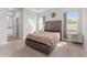 Bedroom featuring elegant bed, mirrored accents, and plenty of natural light through large windows at 14055 Sw 30Th Terrace Rd, Ocala, FL 34473