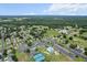 Aerial view of community amenities including tennis courts, swimming pool, recreation center and neighborhood streets at 14481 Sw 112Th Cir, Dunnellon, FL 34432