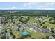 Aerial view of community amenities including tennis courts, swimming pool, recreation center and neighborhood streets at 14481 Sw 112Th Cir, Dunnellon, FL 34432