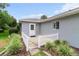 Home exterior with a patio enclosed by a white picket fence and manicured landscaping at 14481 Sw 112Th Cir, Dunnellon, FL 34432