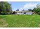 Expansive backyard featuring lush green grass, providing ample space for outdoor activities at 14481 Sw 112Th Cir, Dunnellon, FL 34432