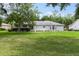 Spacious, green backyard offering a serene setting with mature trees and manicured landscaping at 14481 Sw 112Th Cir, Dunnellon, FL 34432