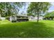 Lush backyard features mature trees and manicured shrubbery providing a serene outdoor setting at 14481 Sw 112Th Cir, Dunnellon, FL 34432