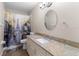 Bathroom with decorative shower curtain, granite countertop, and modern fixtures at 14481 Sw 112Th Cir, Dunnellon, FL 34432