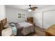 Cozy bedroom featuring wood floors, a decorative ceiling fan, and ample closet space at 14481 Sw 112Th Cir, Dunnellon, FL 34432