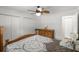 Comfortable bedroom featuring a ceiling fan, wood floors, and ample closet space at 14481 Sw 112Th Cir, Dunnellon, FL 34432
