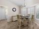 Charming breakfast nook with a round table, plantation shutters, and wood-look tile flooring at 14481 Sw 112Th Cir, Dunnellon, FL 34432