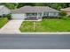 Charming single-story home featuring a well-manicured lawn, attached garage, and inviting front porch at 14481 Sw 112Th Cir, Dunnellon, FL 34432