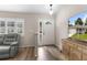 Welcoming foyer featuring wood-look tile flooring, a modern front door, and plenty of natural light at 14481 Sw 112Th Cir, Dunnellon, FL 34432