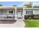 Inviting front porch with decorative pillars, chairs, and a well-manicured lawn at 14481 Sw 112Th Cir, Dunnellon, FL 34432