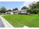 Well-maintained home with vibrant green lawn, mature trees, and inviting curb appeal at 14481 Sw 112Th Cir, Dunnellon, FL 34432
