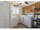 Bright laundry room with washer, dryer, and ample storage space at 14481 Sw 112Th Cir, Dunnellon, FL 34432
