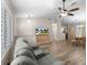 Cozy living room featuring wood-look tile, ceiling fan, and open layout to dining area, perfect for modern living at 14481 Sw 112Th Cir, Dunnellon, FL 34432