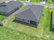 A bird's eye perspective captures the home's backyard, enclosed by a fence, with a screened patio, promoting outdoor enjoyment at 16192 Se 104Th Ter, Summerfield, FL 34491