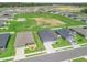 An elevated view highlights a residential area, surrounded by open fields and new constructions, portraying a growing community at 16192 Se 104Th Ter, Summerfield, FL 34491