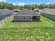 A picturesque backyard featuring a covered patio, lush greenery, and privacy fencing, offering a serene outdoor retreat at 16192 Se 104Th Ter, Summerfield, FL 34491