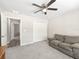 Bedroom with a ceiling fan, carpet, and view to another bedroom and doorway at 16192 Se 104Th Ter, Summerfield, FL 34491