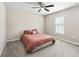 Bedroom featuring a bed, ceiling fan, window, and plush carpeting at 16192 Se 104Th Ter, Summerfield, FL 34491