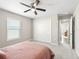 Bright bedroom with a ceiling fan, carpet, double door closet, and window at 16192 Se 104Th Ter, Summerfield, FL 34491