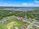 A scenic community aerial view with a lake backdrop, offering a blend of residential living and natural beauty at 16192 Se 104Th Ter, Summerfield, FL 34491