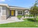 Inviting front entrance with covered porch, stone accents, and landscaped garden beds for added charm at 16192 Se 104Th Ter, Summerfield, FL 34491