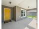 Welcoming front porch featuring a bright yellow door, recessed lighting, and a comfortable entryway at 16192 Se 104Th Ter, Summerfield, FL 34491