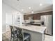 Modern kitchen features a marble island, stainless steel appliances, and breakfast bar seating at 16192 Se 104Th Ter, Summerfield, FL 34491