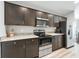Kitchen features stainless steel appliances, granite countertops, and dark wood cabinets at 16192 Se 104Th Ter, Summerfield, FL 34491