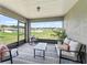 Relaxing screened lanai with seating, a rug, and peaceful backyard views at 16192 Se 104Th Ter, Summerfield, FL 34491