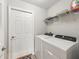 Well-lit laundry room equipped with modern washer and dryer units for convenient laundry care at 16192 Se 104Th Ter, Summerfield, FL 34491