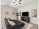 Inviting living room featuring hardwood floors, stylish decor, and a large sectional sofa for relaxation at 16192 Se 104Th Ter, Summerfield, FL 34491
