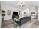 Spacious living room with hardwood floors, comfortable seating, and ample natural light for a cozy atmosphere at 16192 Se 104Th Ter, Summerfield, FL 34491