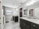 Stylish main bathroom featuring double sinks, granite countertops, and a glass-enclosed shower at 16192 Se 104Th Ter, Summerfield, FL 34491