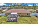 Aerial view of backyard and house with a screened patio, lush lawn, and privacy fence at 16969 Sw 40Th Cir, Ocala, FL 34473