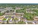 A high aerial shot captures a residential area with mature trees, showcasing the layout of homes and streets at 16969 Sw 40Th Cir, Ocala, FL 34473