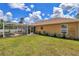 The property features a backyard with lush green grass, an outdoor patio and flower beds at 16969 Sw 40Th Cir, Ocala, FL 34473