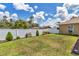 Well maintained backyard with a manicured lawn, flower beds, and a white privacy fence at 16969 Sw 40Th Cir, Ocala, FL 34473