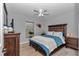 Comfortable bedroom with a ceiling fan and a beautiful wood framed bed and furnishings at 16969 Sw 40Th Cir, Ocala, FL 34473