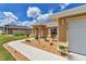 Attractive single-story home featuring a landscaped yard, sidewalk and a two-car garage at 16969 Sw 40Th Cir, Ocala, FL 34473