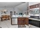 Open kitchen with stainless steel appliances offering a seamless flow to the adjacent dining area at 16969 Sw 40Th Cir, Ocala, FL 34473