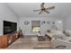 Inviting living room featuring stylish furnishings, a modern ceiling fan, and natural light at 16969 Sw 40Th Cir, Ocala, FL 34473
