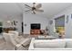 Spacious living room with comfortable seating, a ceiling fan, and a view of the dining area at 16969 Sw 40Th Cir, Ocala, FL 34473