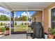Covered patio with a grill, potted plants, and a view of the fenced backyard at 16969 Sw 40Th Cir, Ocala, FL 34473