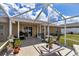 A beautiful screened patio with outdoor furniture is a great place to enjoy the outdoors in comfort at 16969 Sw 40Th Cir, Ocala, FL 34473