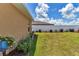 A well-maintained side yard with lush lawn, garden beds, and a white privacy fence at 16969 Sw 40Th Cir, Ocala, FL 34473