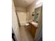 Clean, functional bathroom with tiled floor and shower and a granite vanity at 24 Malauka Ter, Ocklawaha, FL 32179