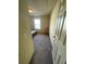 Simple carpeted bedroom featuring a window, chair, and a bed at 24 Malauka Ter, Ocklawaha, FL 32179