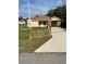 Charming single-story home featuring a well-maintained lawn, and a quaint decorative fence at 24 Malauka Ter, Ocklawaha, FL 32179