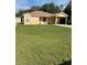 Charming home featuring a well-maintained lawn and a convenient carport at 24 Malauka Ter, Ocklawaha, FL 32179